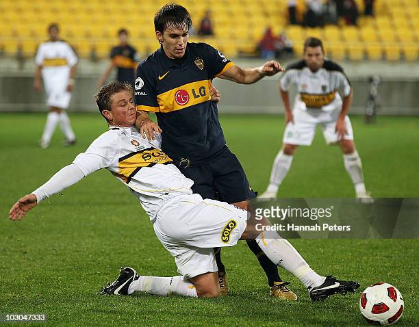 Ben Sigmund of the Phoenix tries to kick the ball past Pablo Mouche of the Boca Juniors during the pre-season friendly match between Wellington...