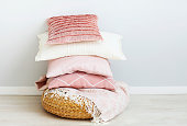 Pink and white pillows on the wall background