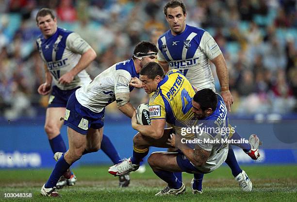 Timana Tahu of the Eels is tackled during the round 20 NRL match between the Caterbury Bulldogs and the Parramatta Eels at ANZ Stadium on July 23,...