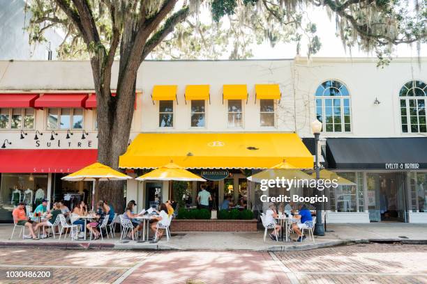 restaurants and shops line park avenue in downtown winter park florida usa - orlando florida imagens e fotografias de stock