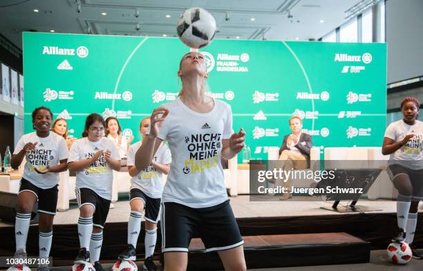Young soccer players perform during the Frauen Bundesliga season opening news conference at Fussball Museum on September 10, 2018 in Dortmund,...