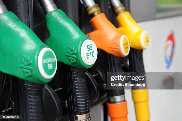 Gas pumps hang at a Total SA gas station in Paris, France, on Thursday, July 22, 2010. The company, Europe's biggest oil refiner, releases its...