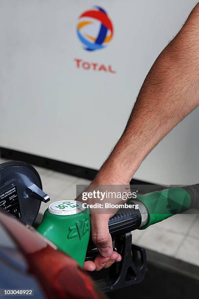 Customer fills his car with fuel at a Total SA gas station in Paris, France, on Thursday, July 22, 2010. The company, Europe's biggest oil refiner,...