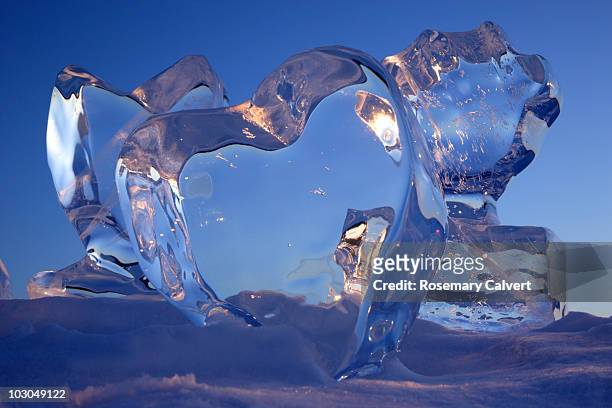 crystal clear heart ice sculptures. - ice sculpture stock-fotos und bilder