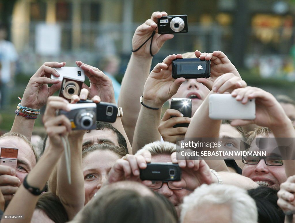 Supporters use their cameras and mobile