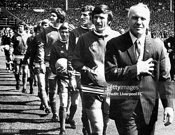 Liverpool manager Bill Shankly proudly holds his chest as he leads his men out into the sunlight prior to the FA Cup Final between Liverpool and...