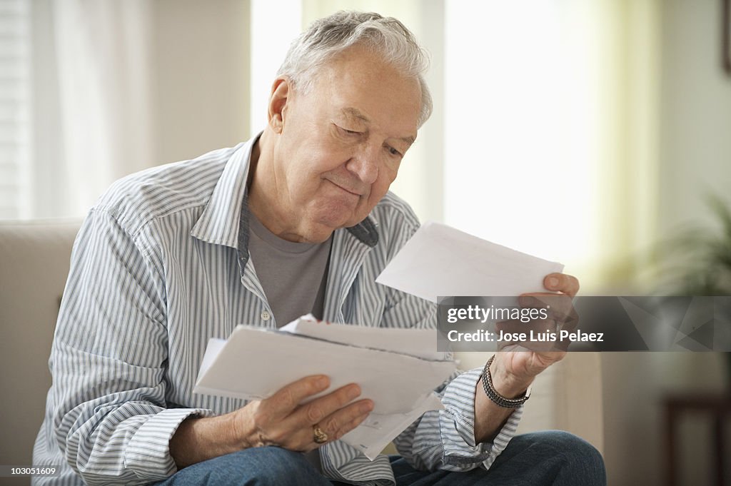 Elderly man going over bills