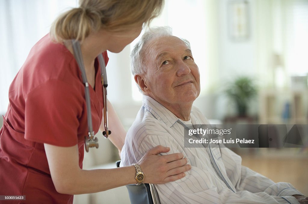 Nurse speaking to elderly man