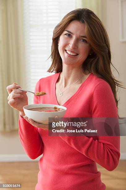 woman eating a bowl of soup - soup bowl stock pictures, royalty-free photos & images