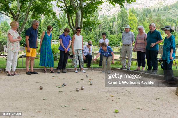 The photo tour members enjoying a game of Petanque in the garden at La Bastide de Moustiers, a house converted to a hotel, in Moustiers-Sainte-Marie,...