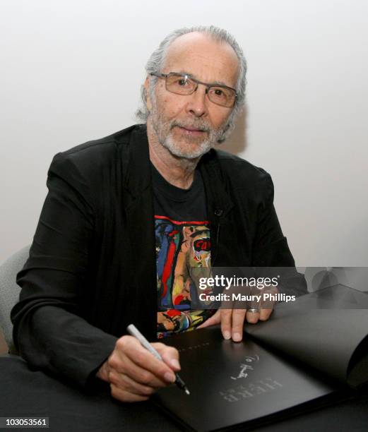 Herb Alpert signs autographs during his Black Totems Exhibition and book signing on July 22, 2010 in Los Angeles, California.