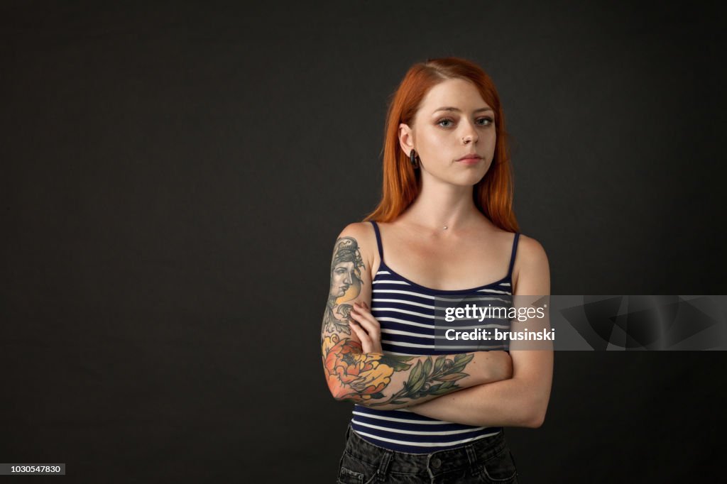 Studio portrait of a tattoo artist on a black background