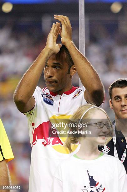 Thierry Henry of the New York Red Bulls reacts to the fans cheers during player introductions prior to the start of the match against Tottenham...