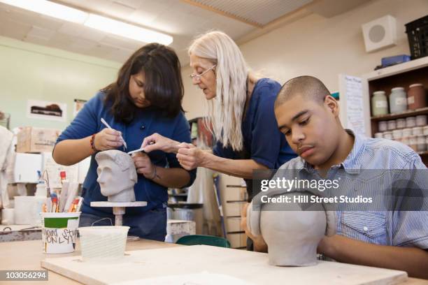 student sculpting bust in classroom - sculpting clay stock pictures, royalty-free photos & images