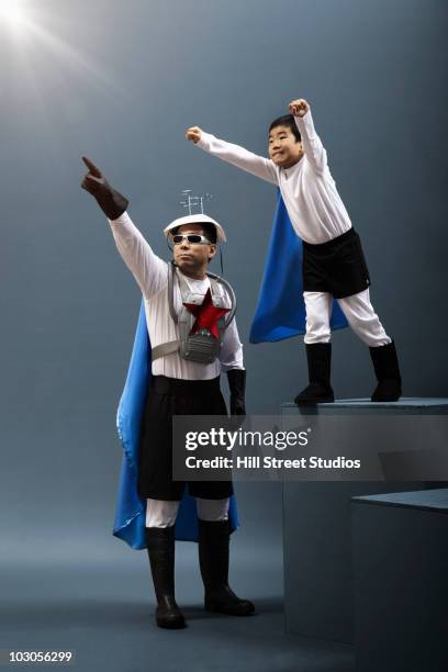 korean boy in superhero costume flying while father watches - strict parent imagens e fotografias de stock