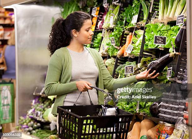 hispanic woman shopping for fresh vegetables - convenience basket stock pictures, royalty-free photos & images