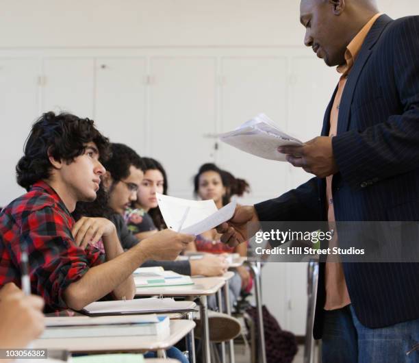 Students Using Paper Teacher Holding Paper Photos and Premium High Res Pictures - Getty Images