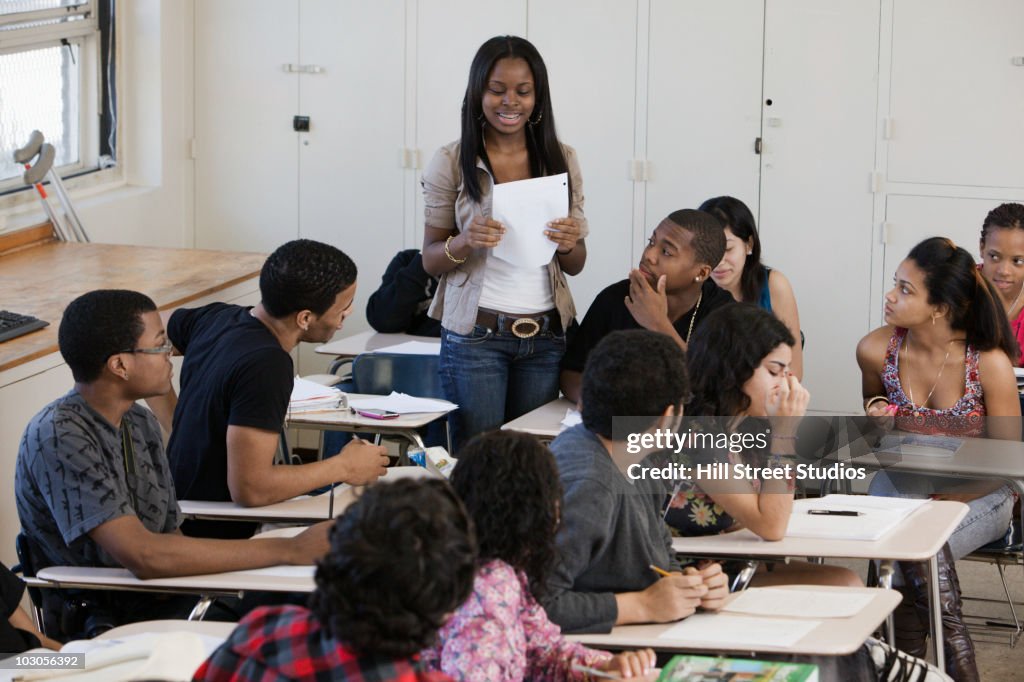 Students Using Paper Student Reading Paper In Classroom High-Res Stock Photo - Getty Images