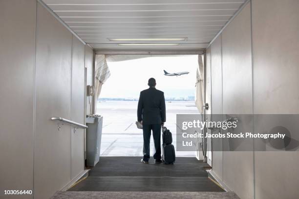 hispanic businessman standing on jetway - american red cross fotografías e imágenes de stock