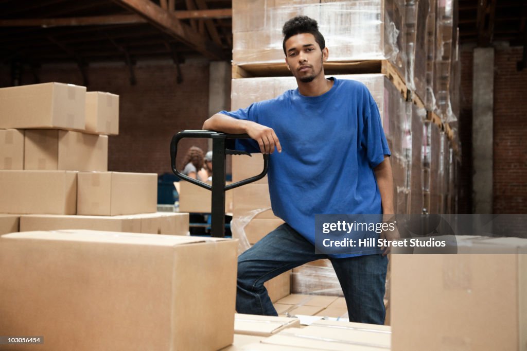 Black man standing in warehouse