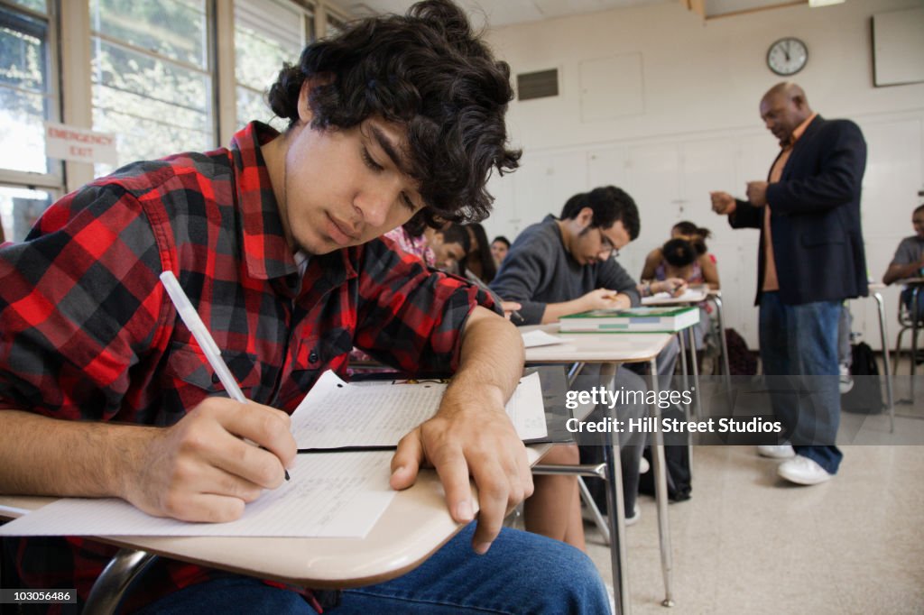 Students writing in classroom