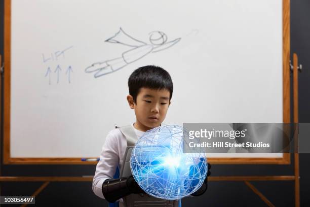 Korean boy looking at glowing orb