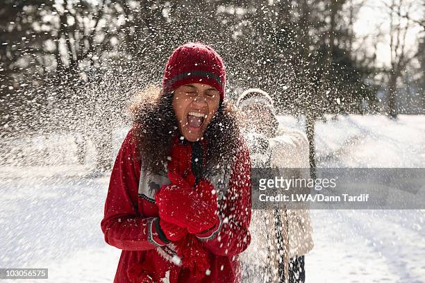 couple having snowball fight - fun snow stockfoto's en -beelden