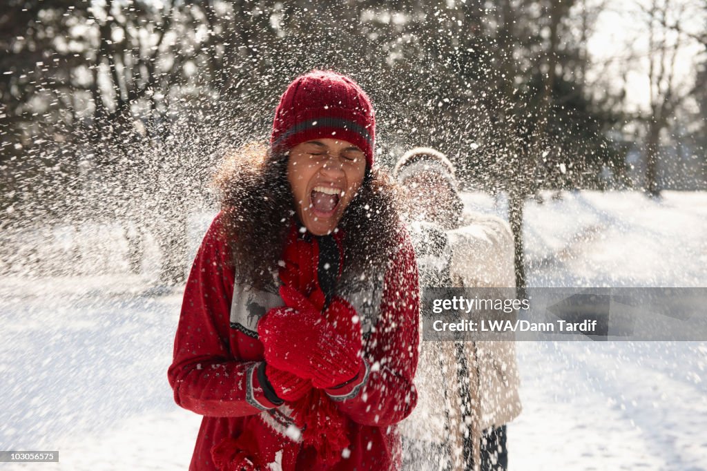 Couple having snowball fight