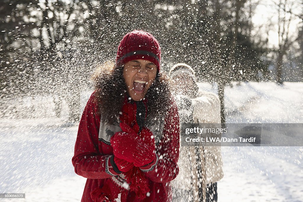 Couple having snowball fight