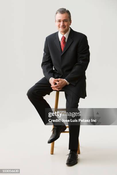 caucasian businessman sitting on stool - damkostym bildbanksfoton och bilder