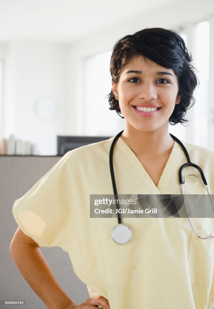 Hispanic nurse in scrubs with stethoscope