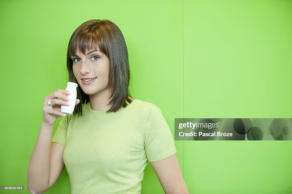 Portrait of a woman drinking probiotic drink