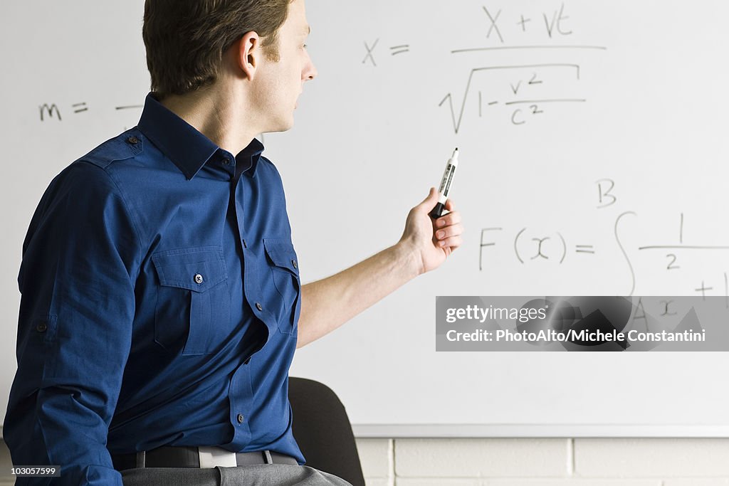Math teacher explaining equation