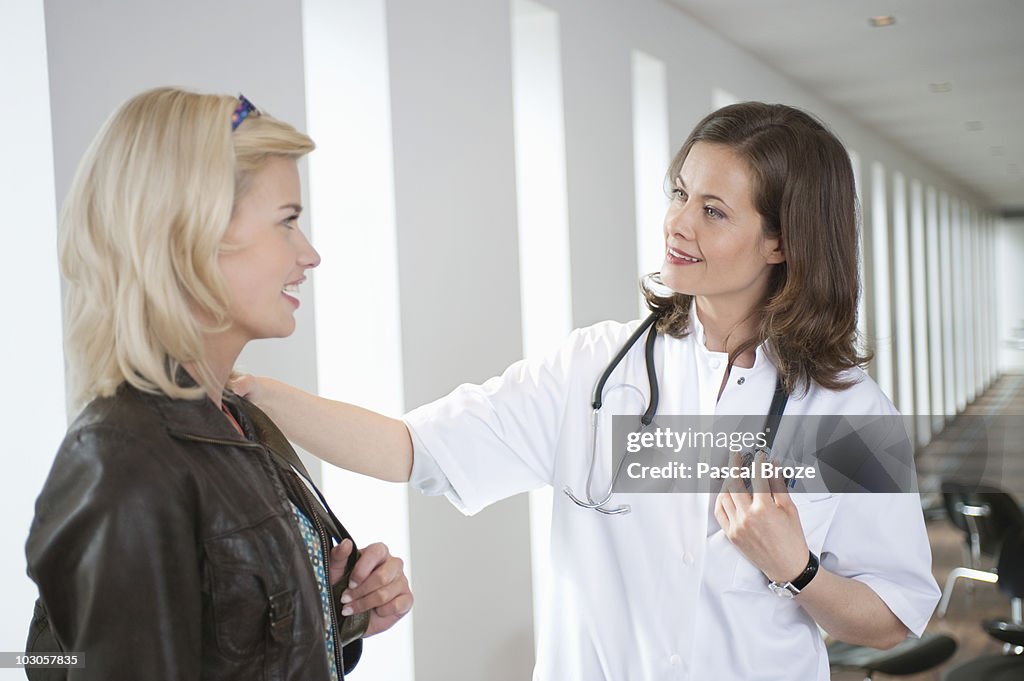 Female doctor consoling a patient