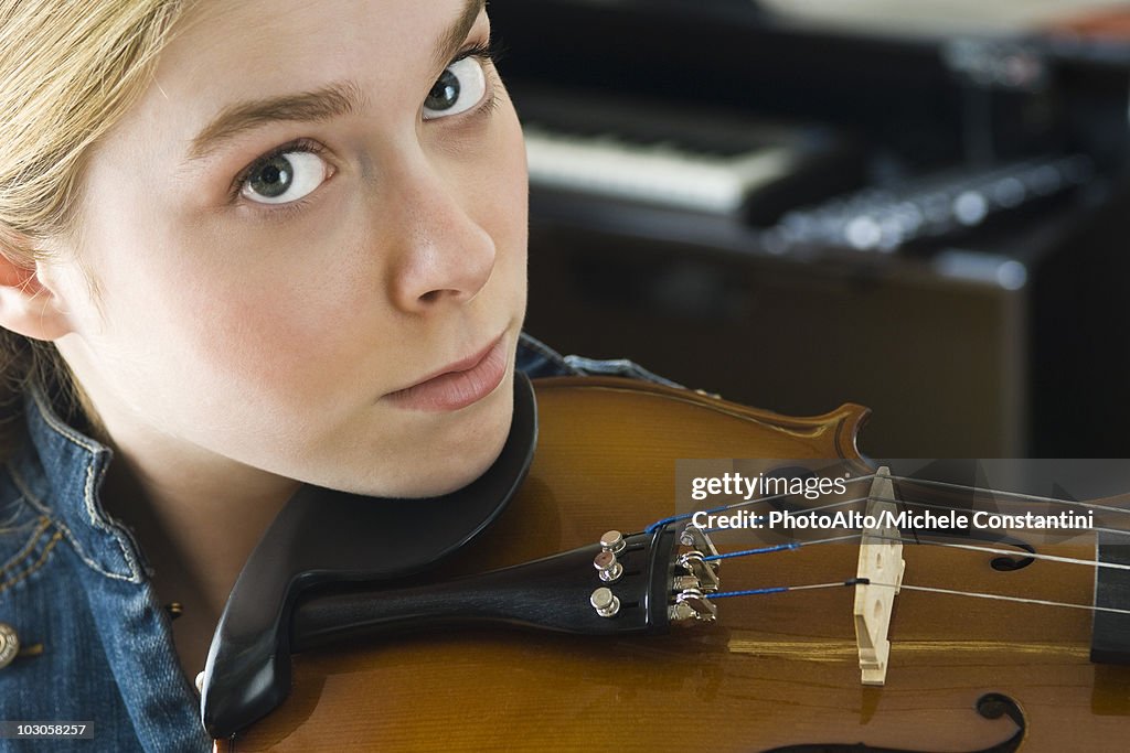 Young woman playing violin, portrait