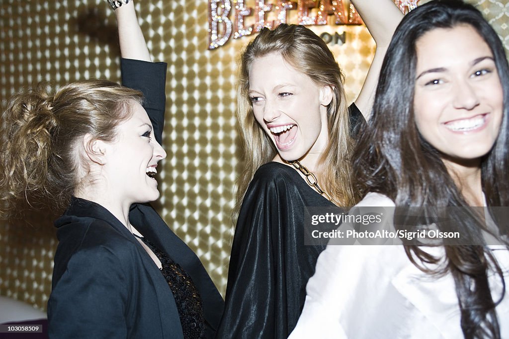 Young women dancing in night club