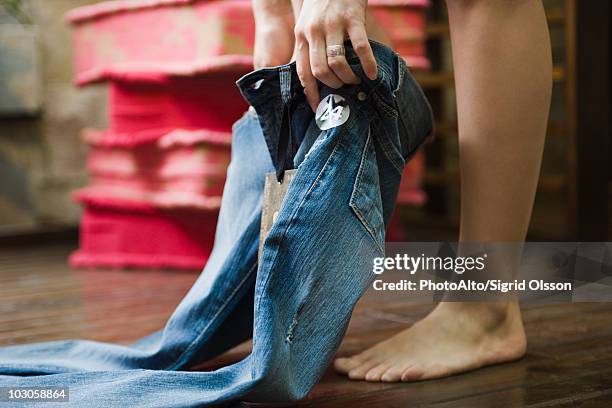 trying on jeans in fitting room - woman jeans stock pictures, royalty-free photos & images