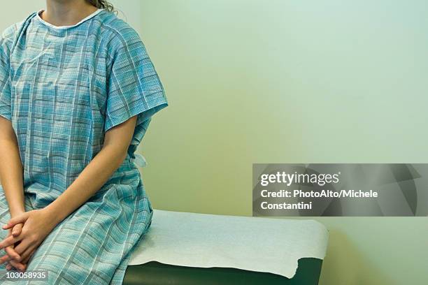 patient waiting on examination table - examination gown stock pictures, royalty-free photos & images