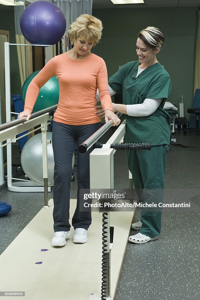 Woman undergoing post-surgery rehabilitation exercises to regain ability to walk