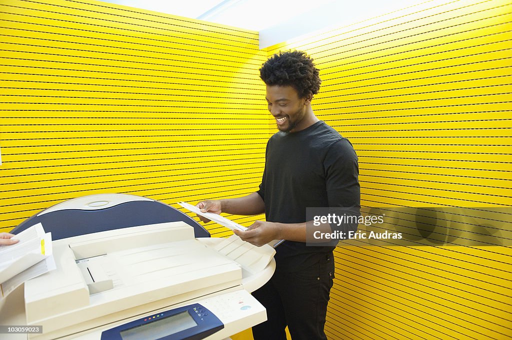 Businessman using a photocopy machine in an office