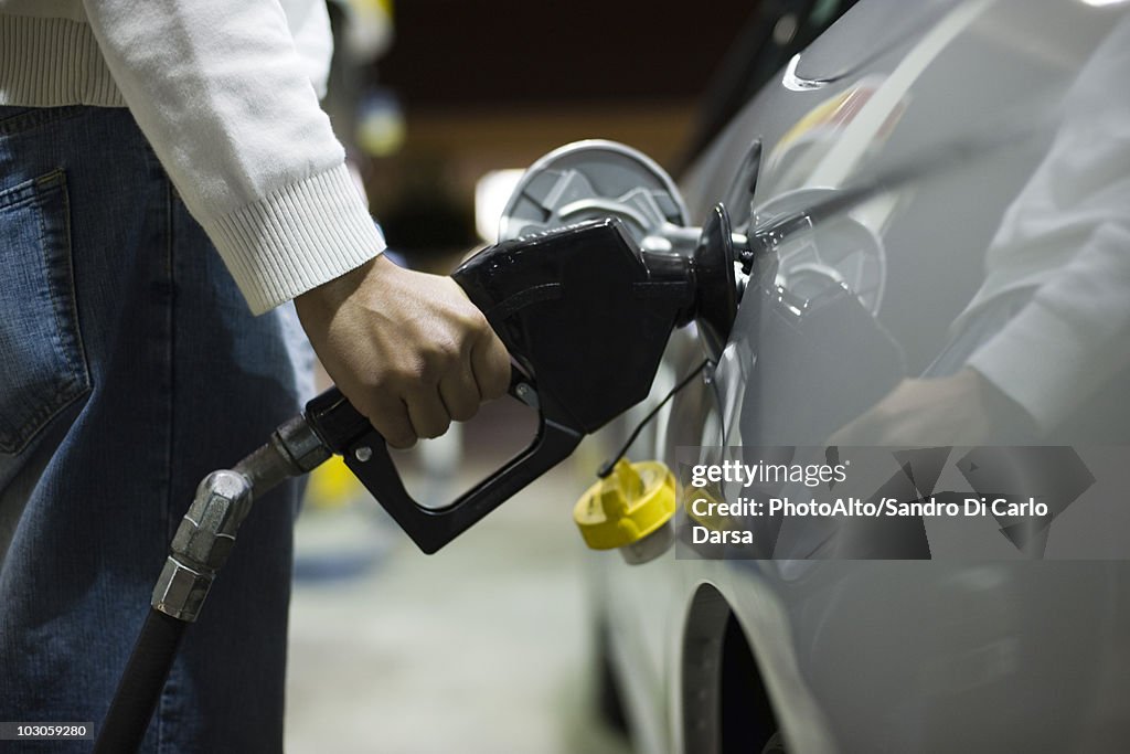 Driver refueling car