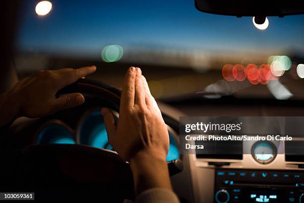 driver drumming hands on steering wheel - steering wheel stock pictures, royalty-free photos & images