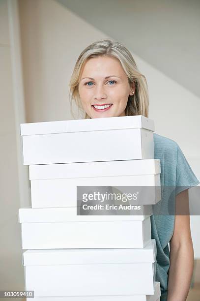 portrait of a woman carrying shoe boxes - shoe box ストックフォトと画像