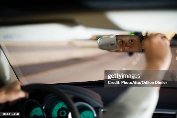 driver driving adjusting rearview mirror - rear view mirror stock pictures, royalty-free photos & images