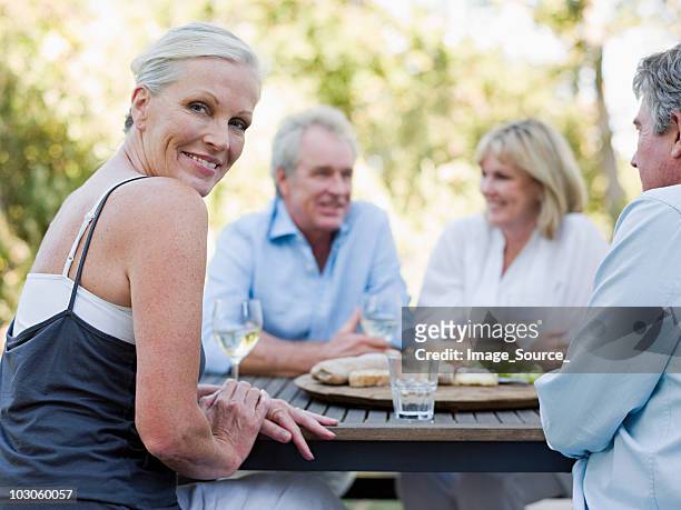 friends at meal outdoors - baby boomer stock pictures, royalty-free photos & images