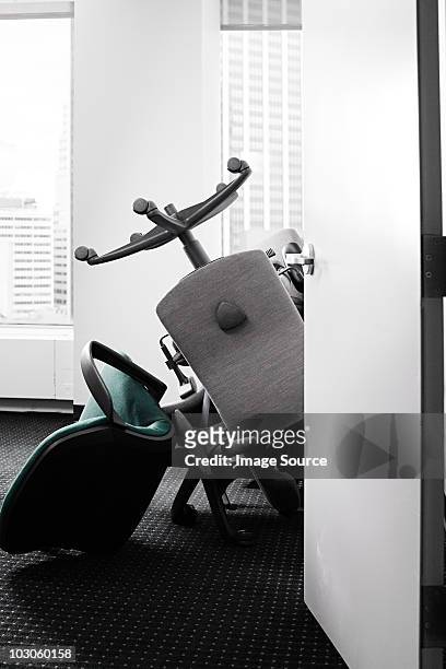 pile of chairs in office - office chair stockfoto's en -beelden