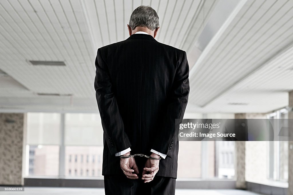 Businessman in handcuffs