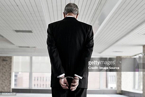 businessman in handcuffs - handcuffs bildbanksfoton och bilder