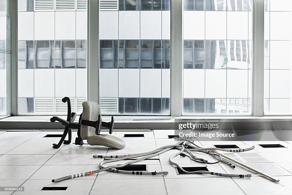 Office chair and cables on floor