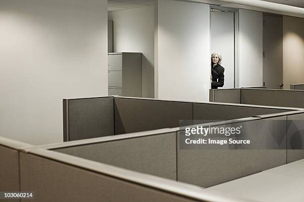 businesswoman hiding in office - peeking cubicle stock pictures, royalty-free photos & images